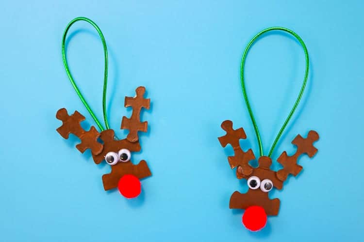 reindeer faces ornaments made from painted puzzle pieces