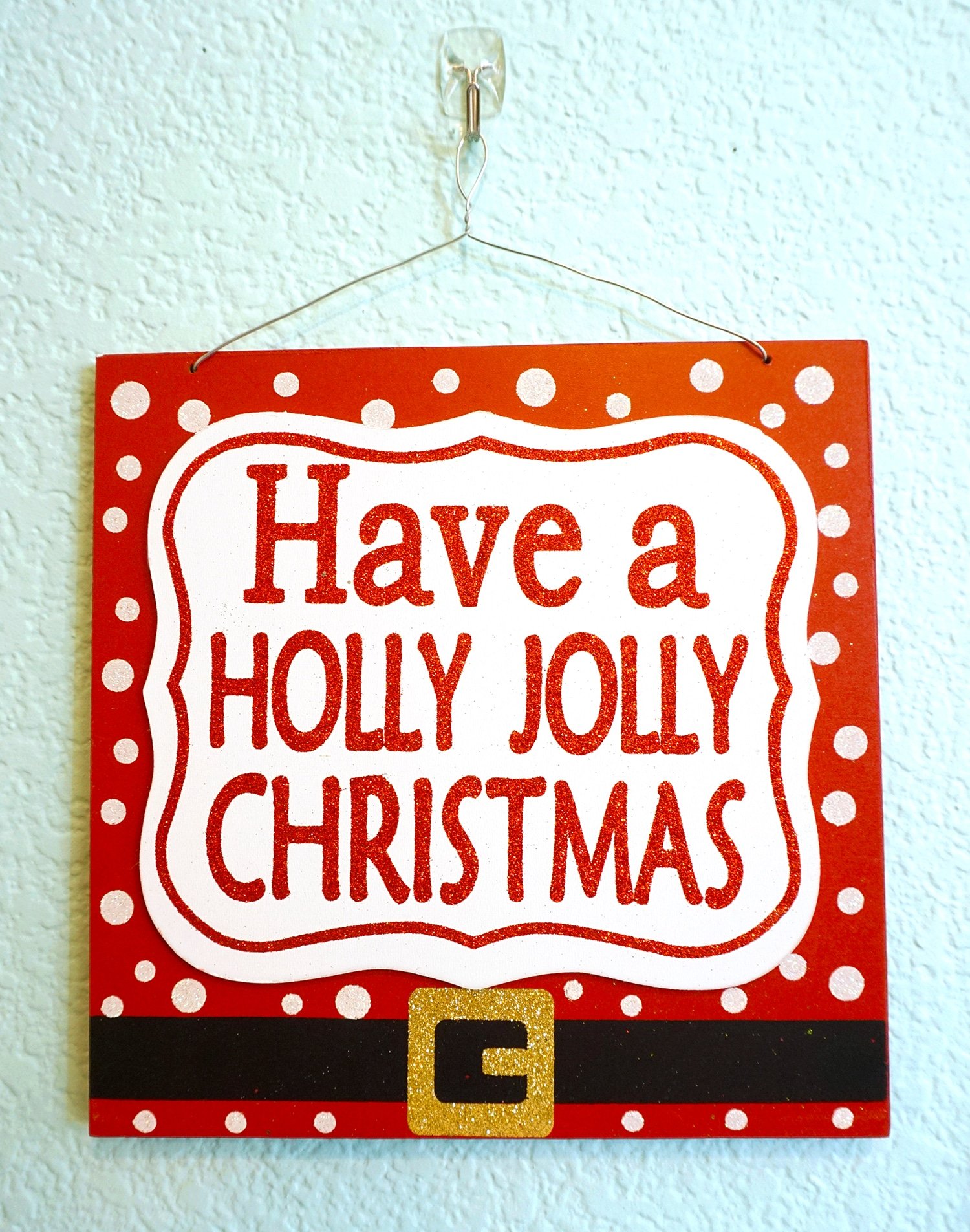 have a holly jolly christmas sign on wall