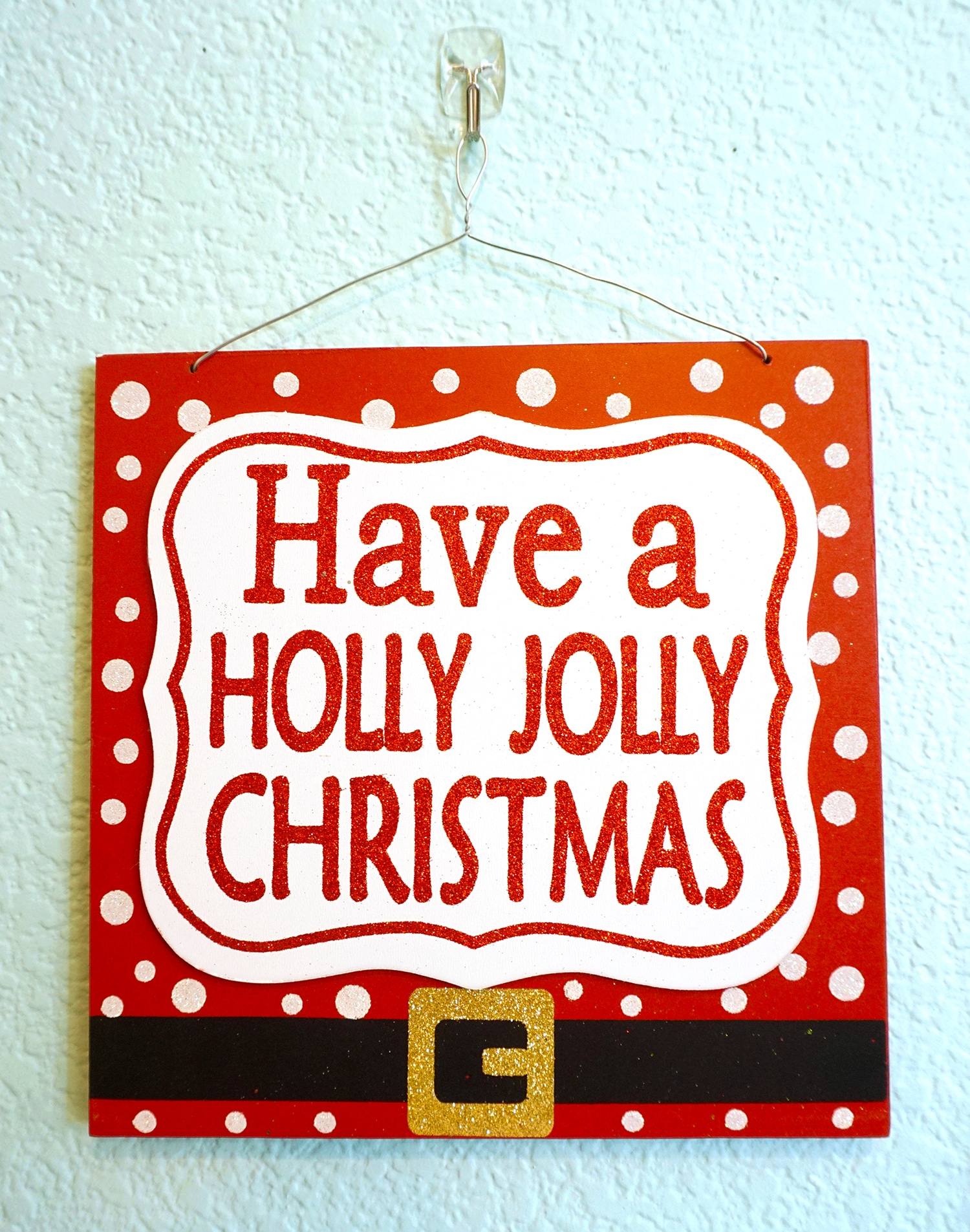 have a holly jolly christmas sign on wall