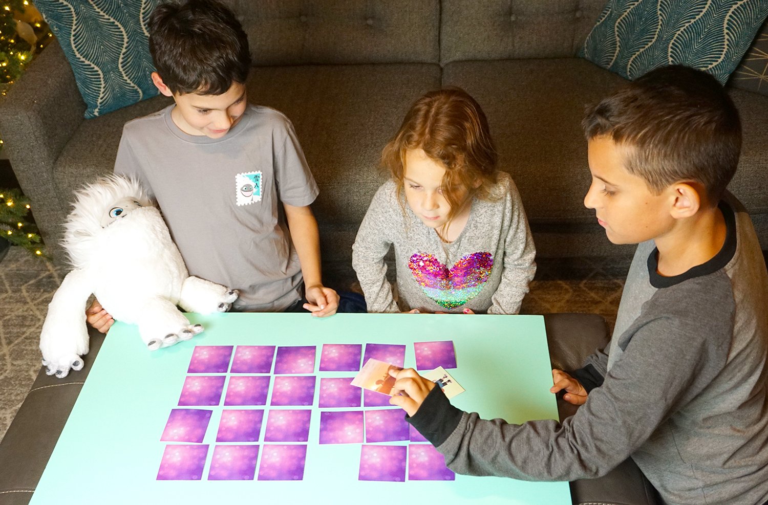 boy showing his memory card game choice to kids