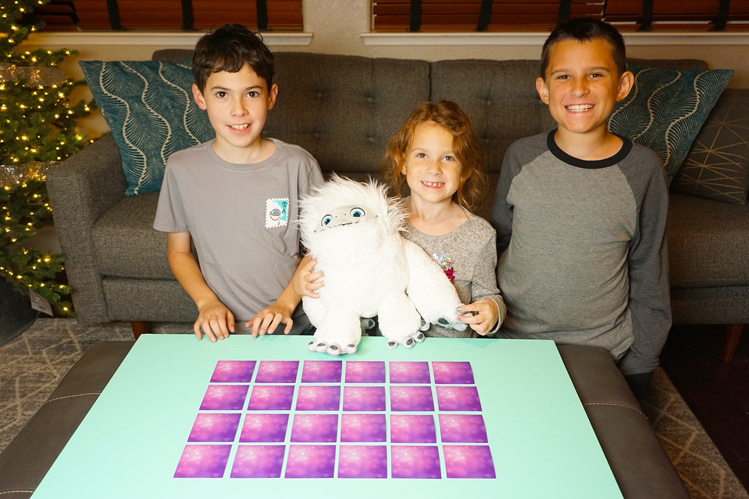 kids smiling with abominable toy ready to play game