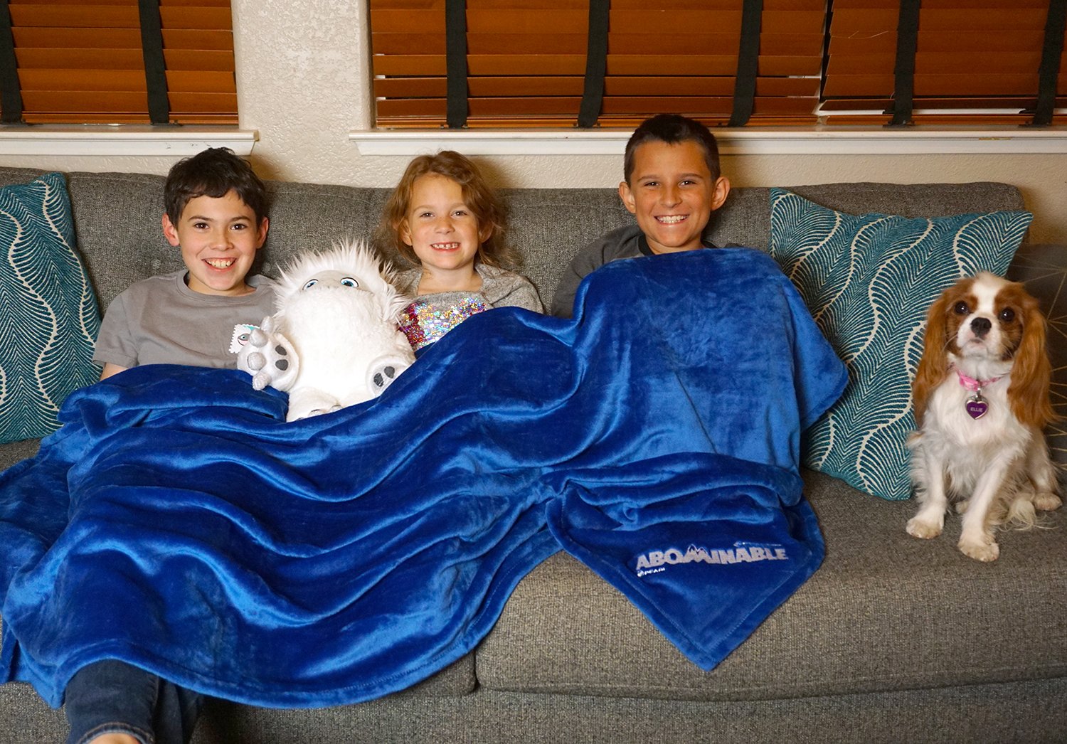 kids snuggled in blanket ready to watch abominable movie