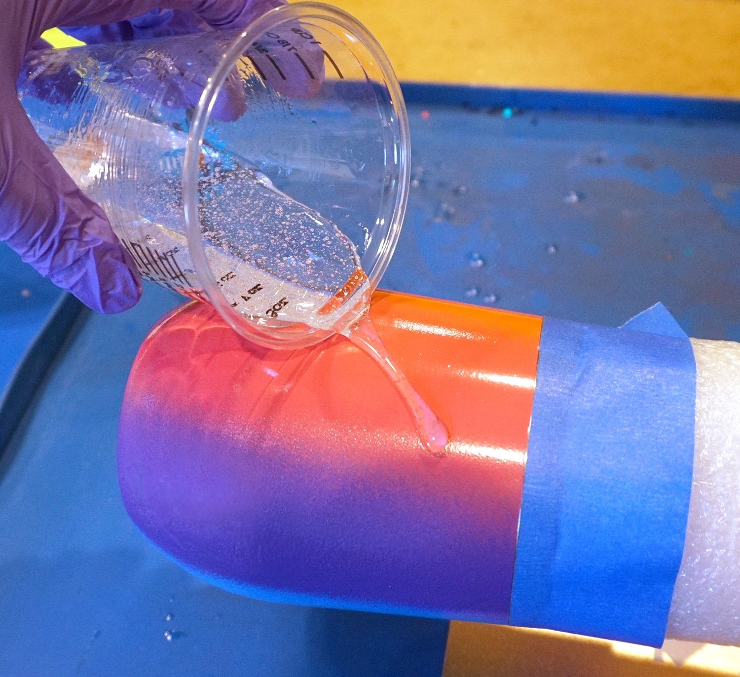 pouring resin over spray painted tumbler