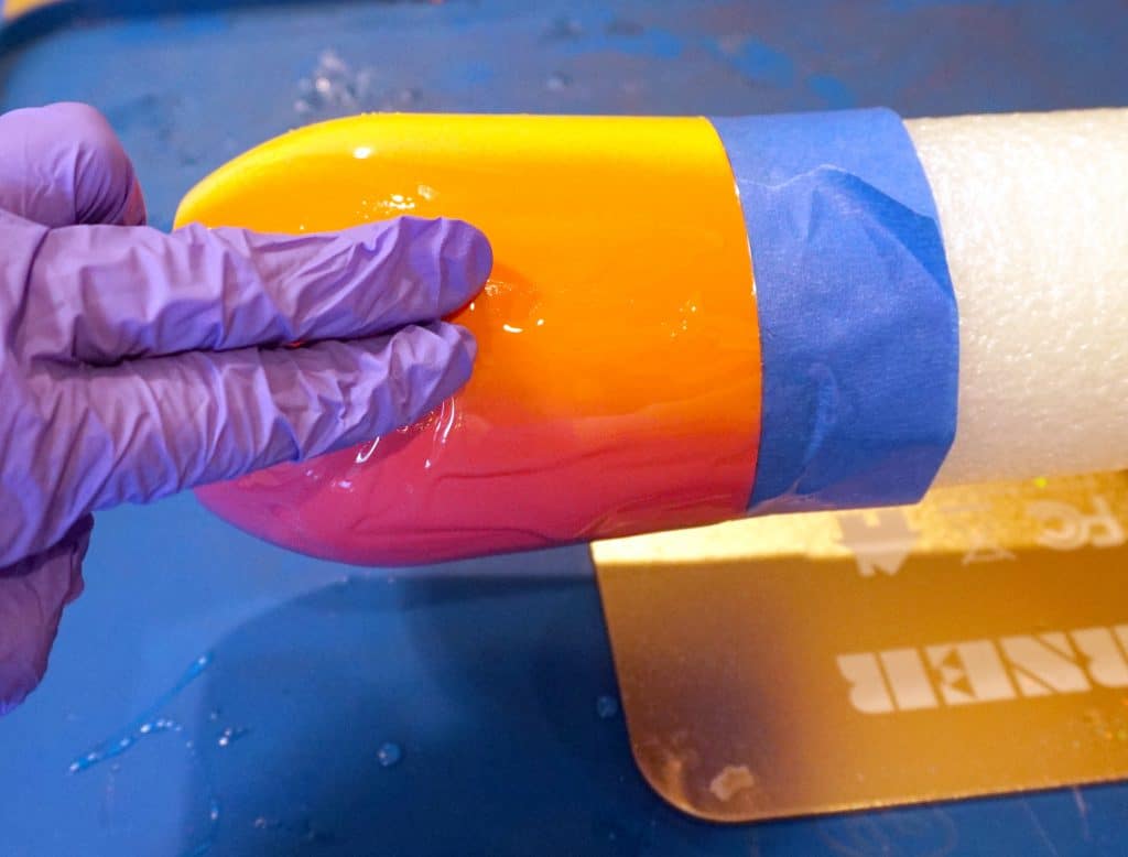 smoothing resin with gloved fingers