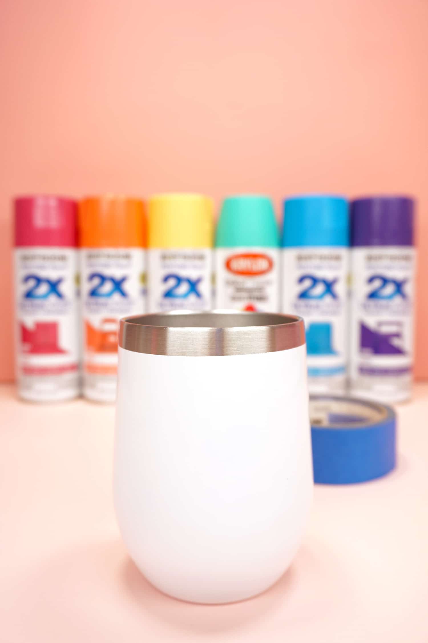 plain white wine tumbler and rainbow of spray paint colors