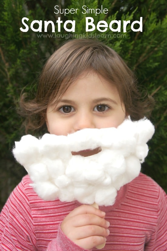child wearing fake santa clause beard made from paper plate and cotton balls 