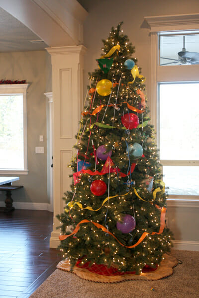 christmas tree decorated with balloons for fun new years eve game