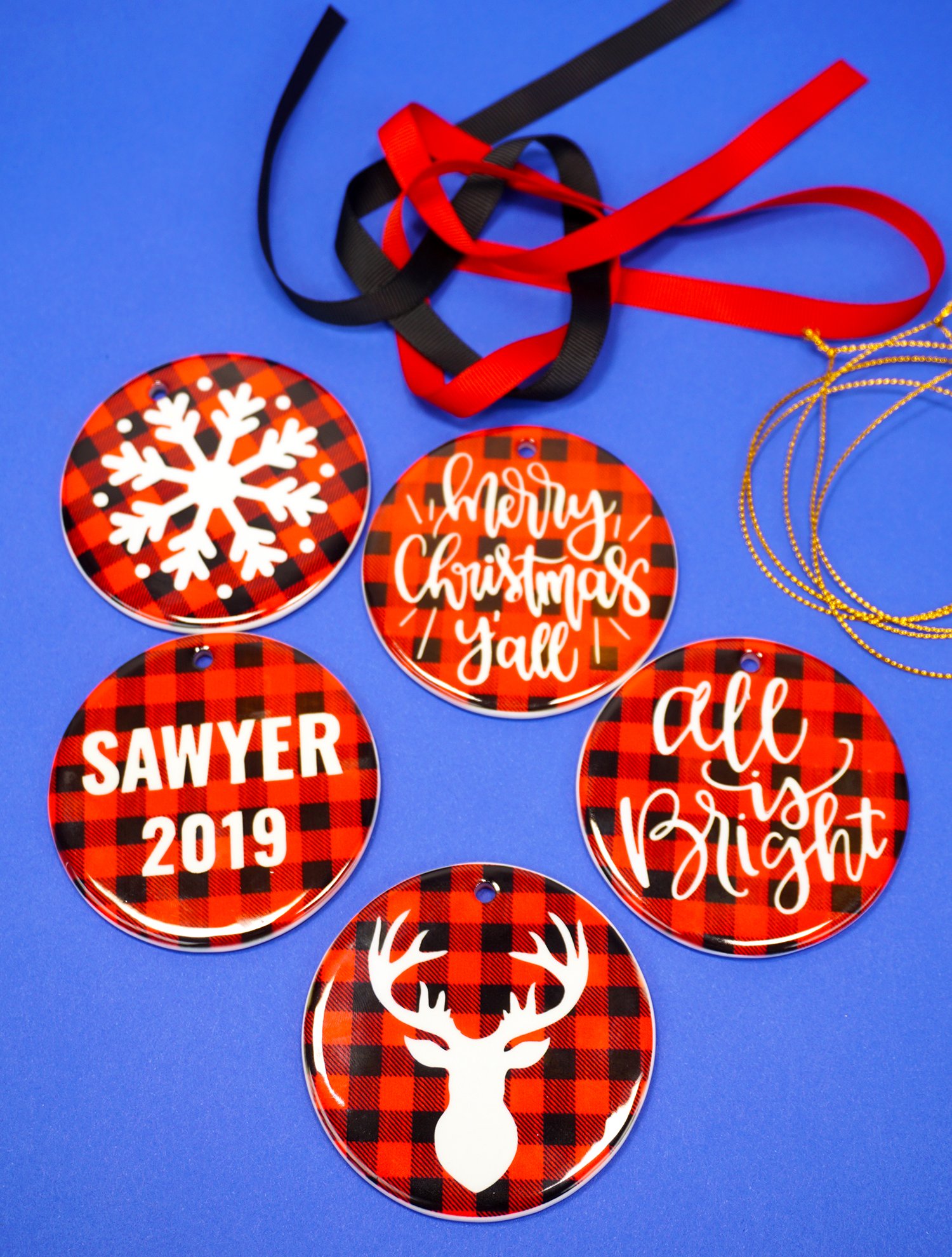 five completed red buffalo plaid christmas ornaments and ribbons