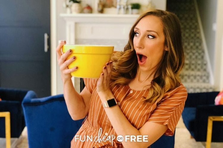 lady holding yellow bowl making a surprised expression