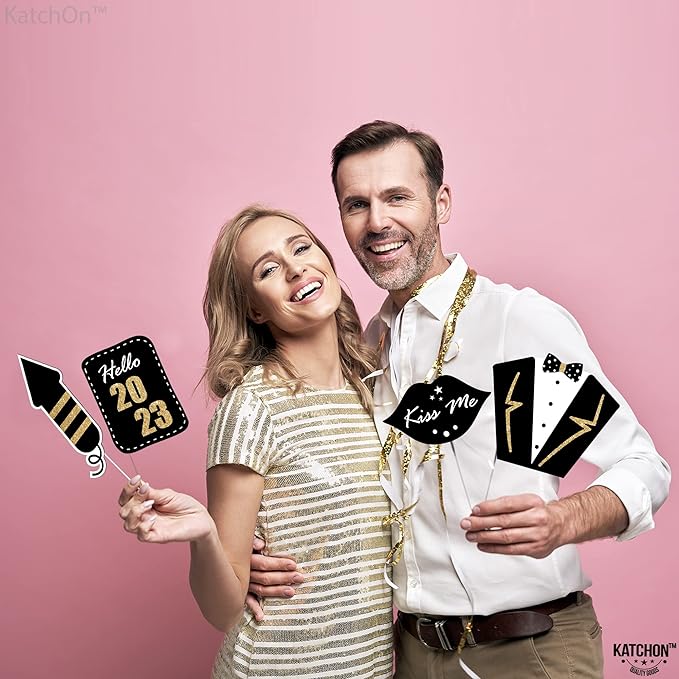 couple holding new year eve photo props