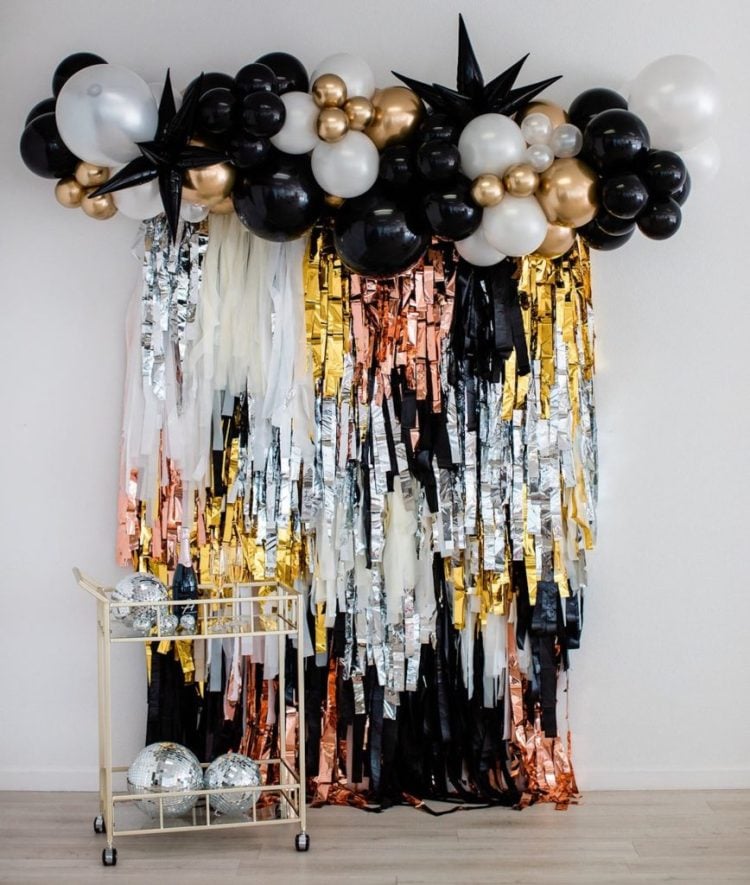 new year photo backdrop with balloons and cart