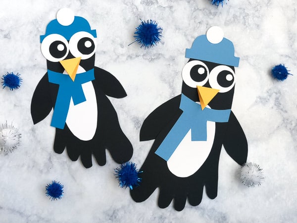 foot prints on paper turned into penguins with scarves