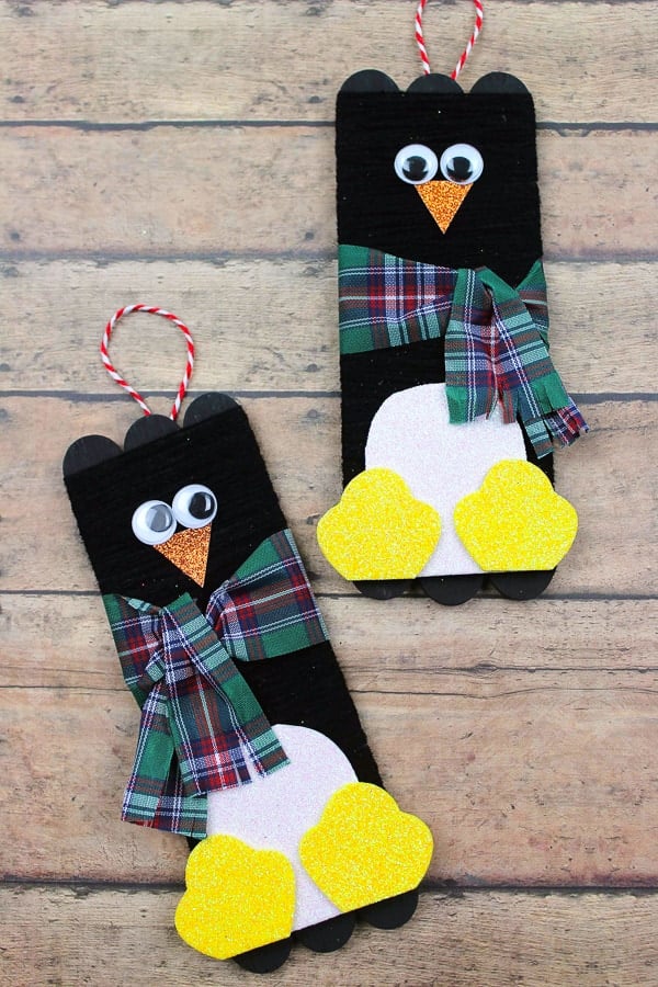 wooden craft sticks made into two penguins with scarves