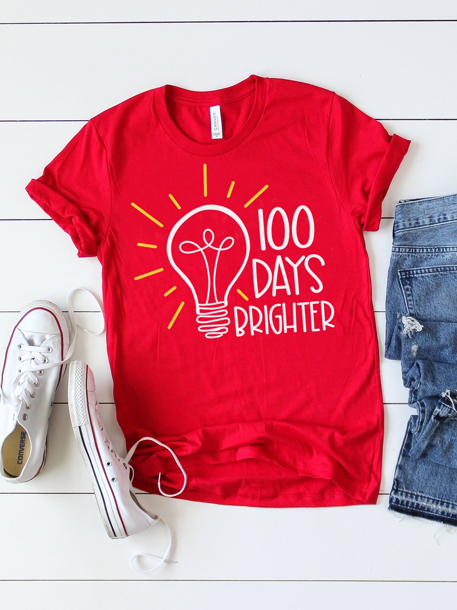 100 days brighter svg file on red tee with stylized accessories
