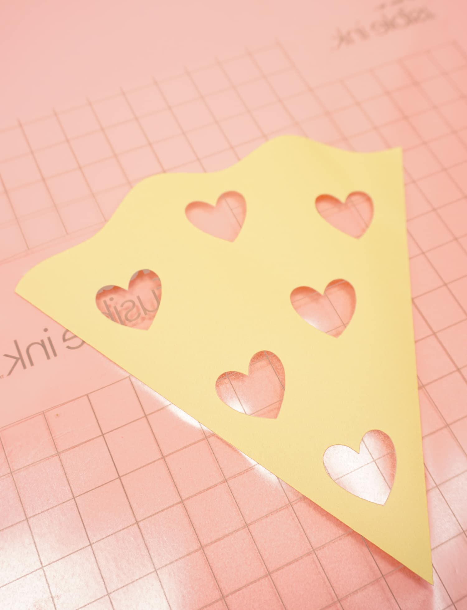 cut pizza file with hearts cut out of it 