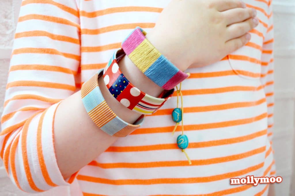 craft sticks made into bracelets worn by child