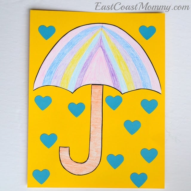 umbrella colored on paper with blue paper hearts as rain