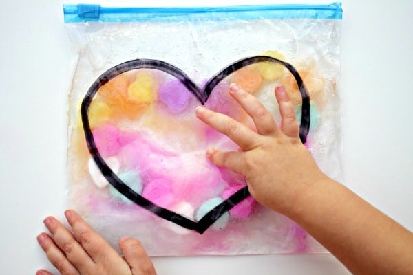 kid squishing valentines sensory squish bag