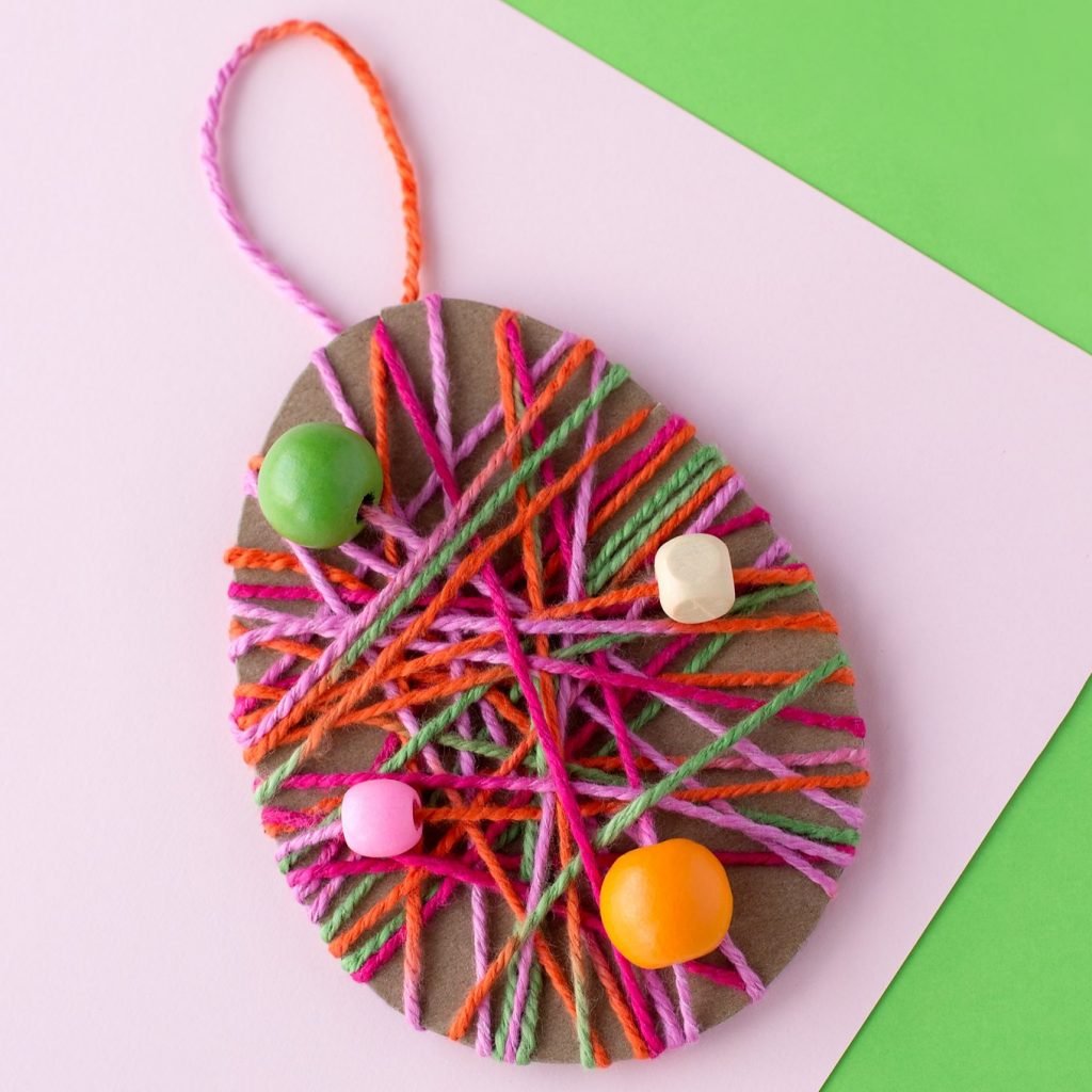 easter egg covered in string art and beads