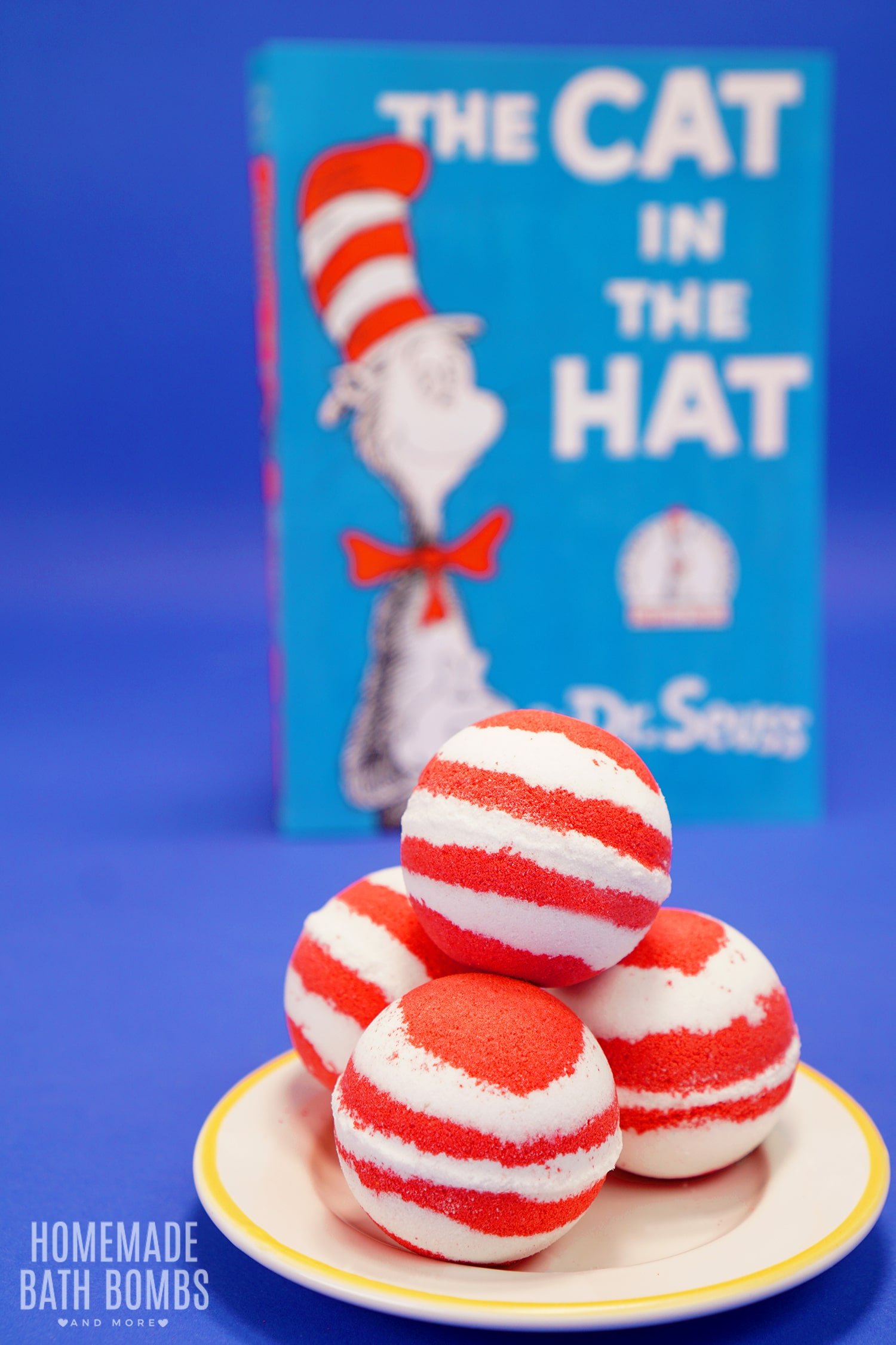 cat in the hat themed red and white striped bath bombs with book