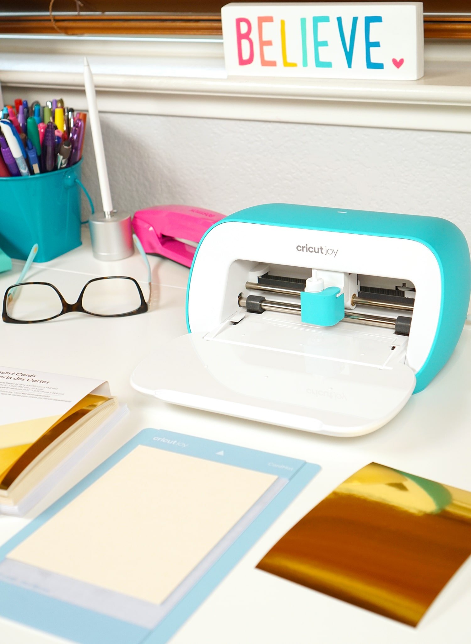 cricut joy on desk with office supplies