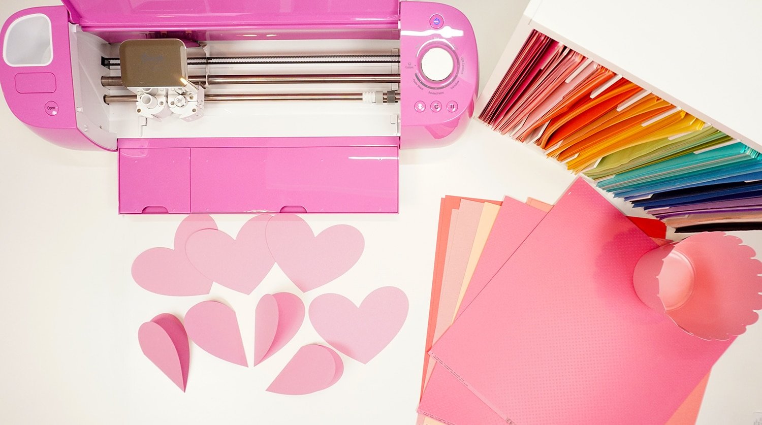 cricut machine with paper cut out hearts and pink paper