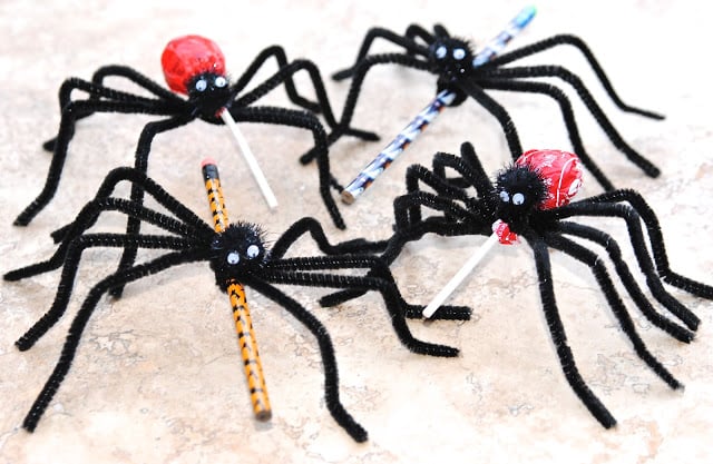pipe cleaners made into spiders with candy and pencils