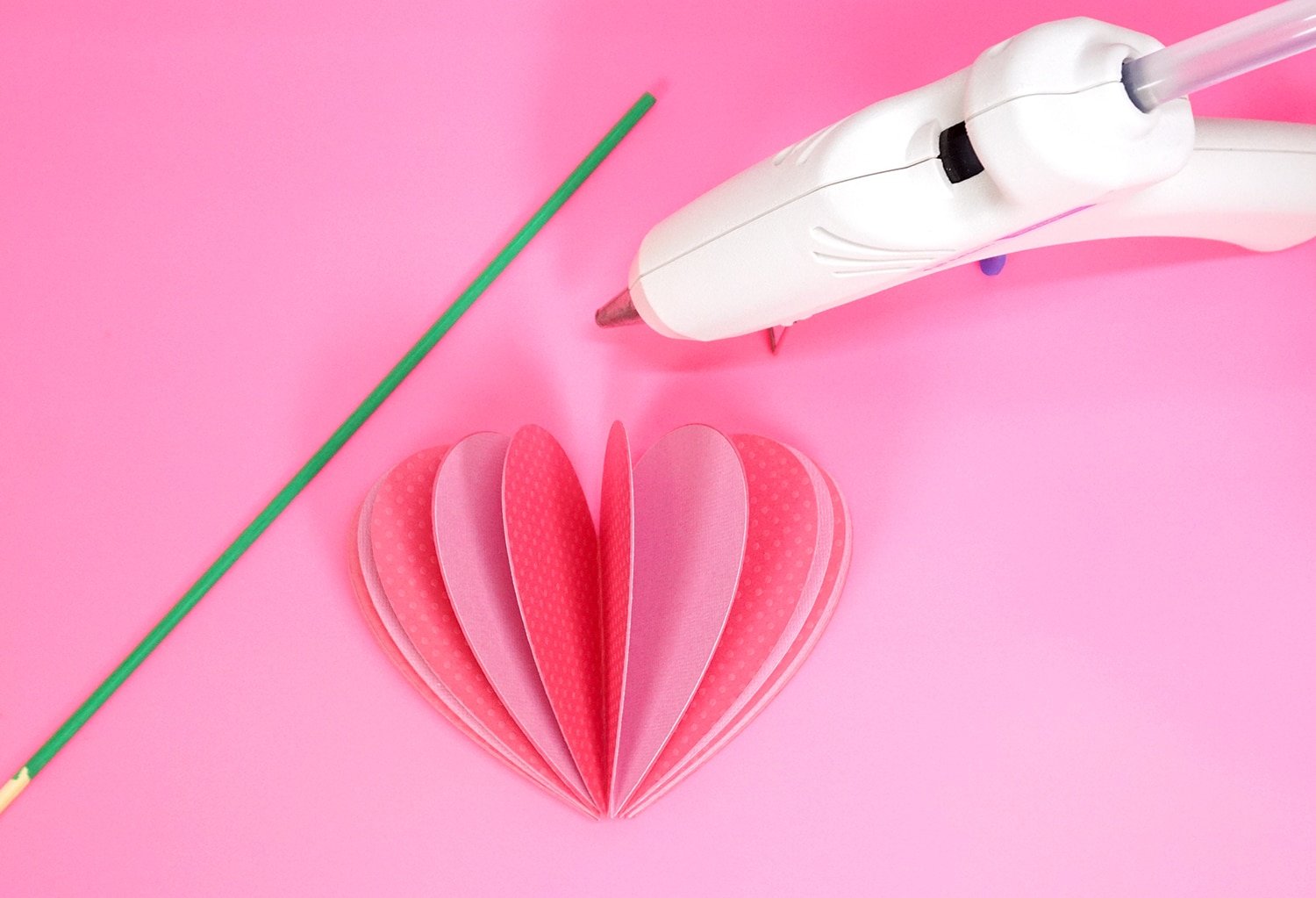 glueing stem onto paper heart 3d flower