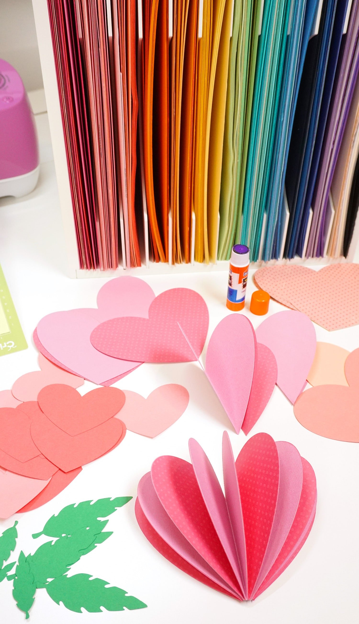 paper hearts being glued into 3D flowers