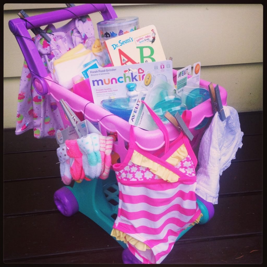 toy shopping cart filled with toys and clothes for a girl