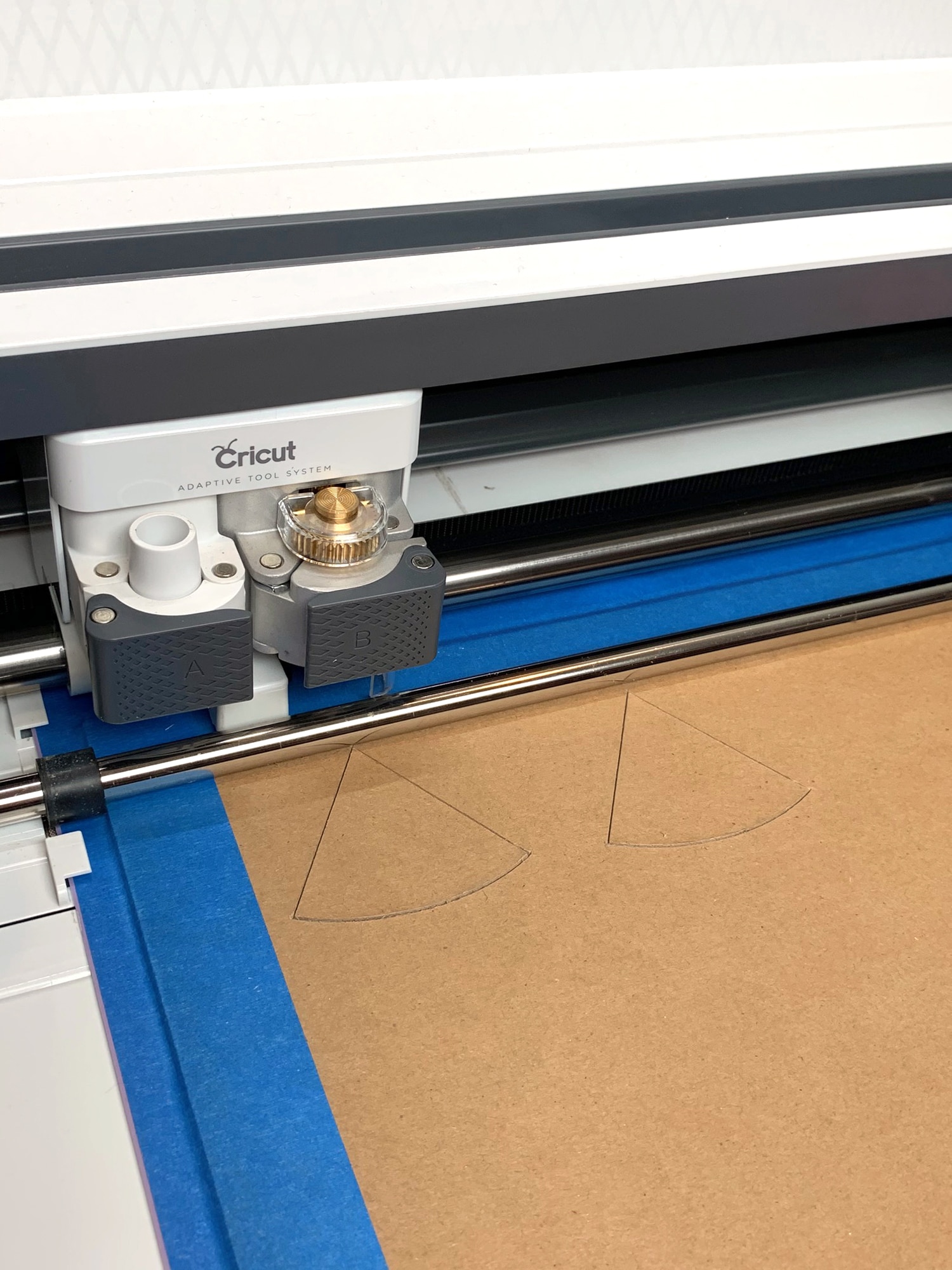 cricut maker cutting earrings out of chipboard