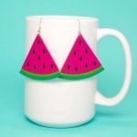diy watermelon slice earrings hanging on mug