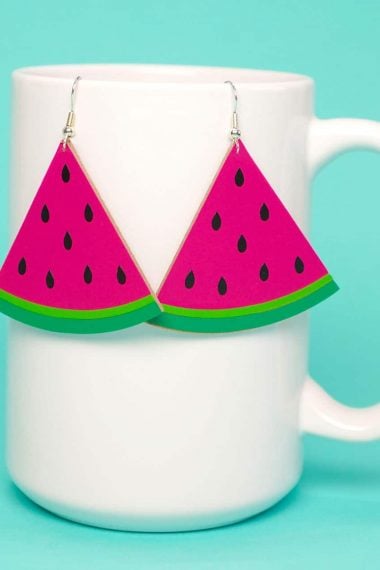 diy watermelon slice earrings hanging on mug