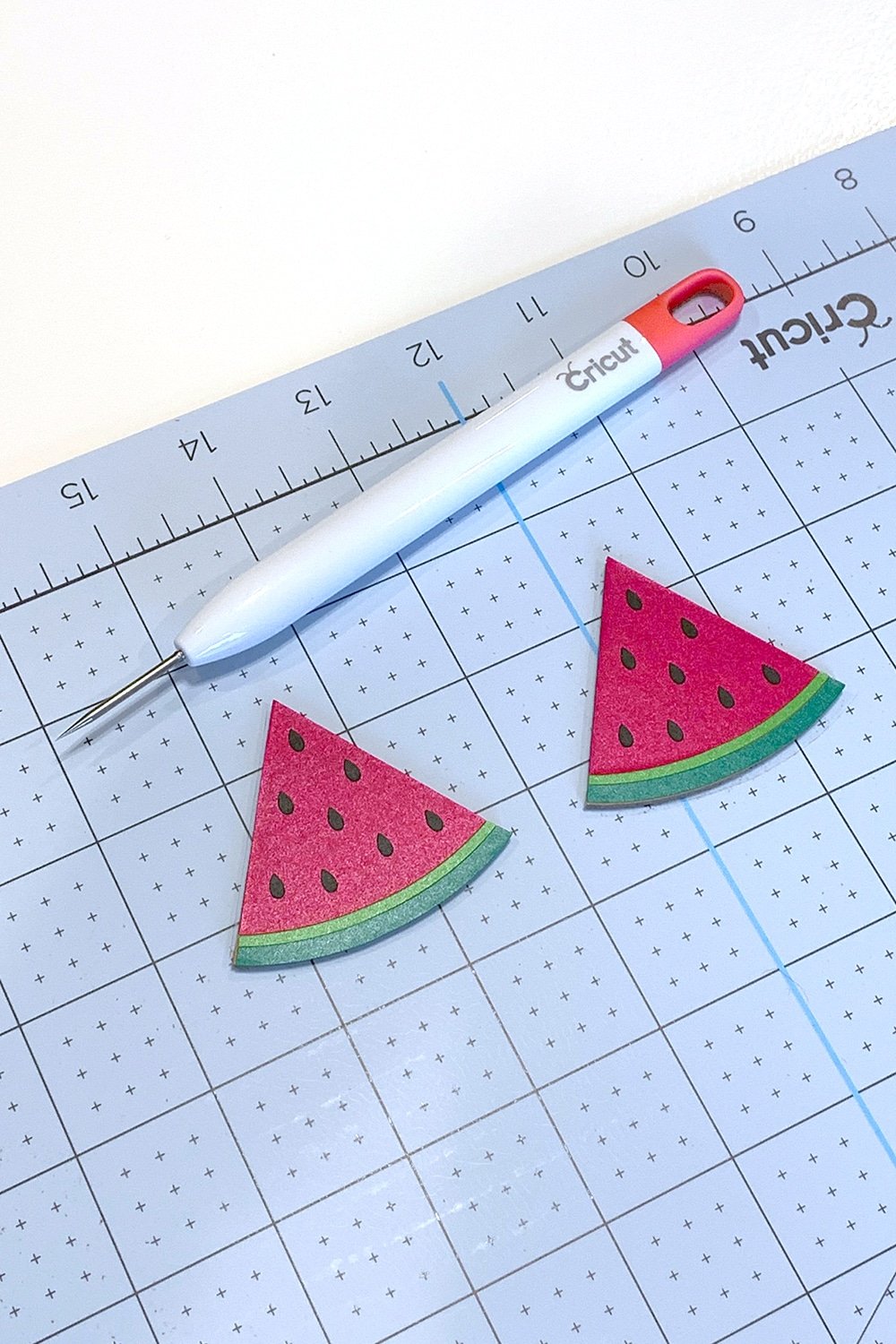 cricut craft tools on cutting mat with watermelon slice earrings