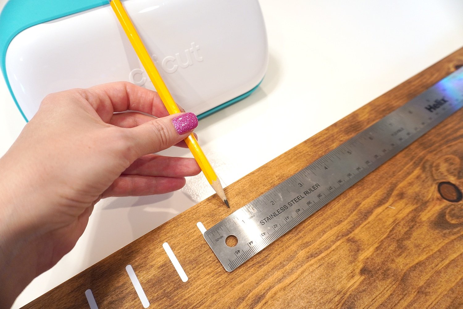 marking the spacing with a pencil and foot ruler on the growth chart