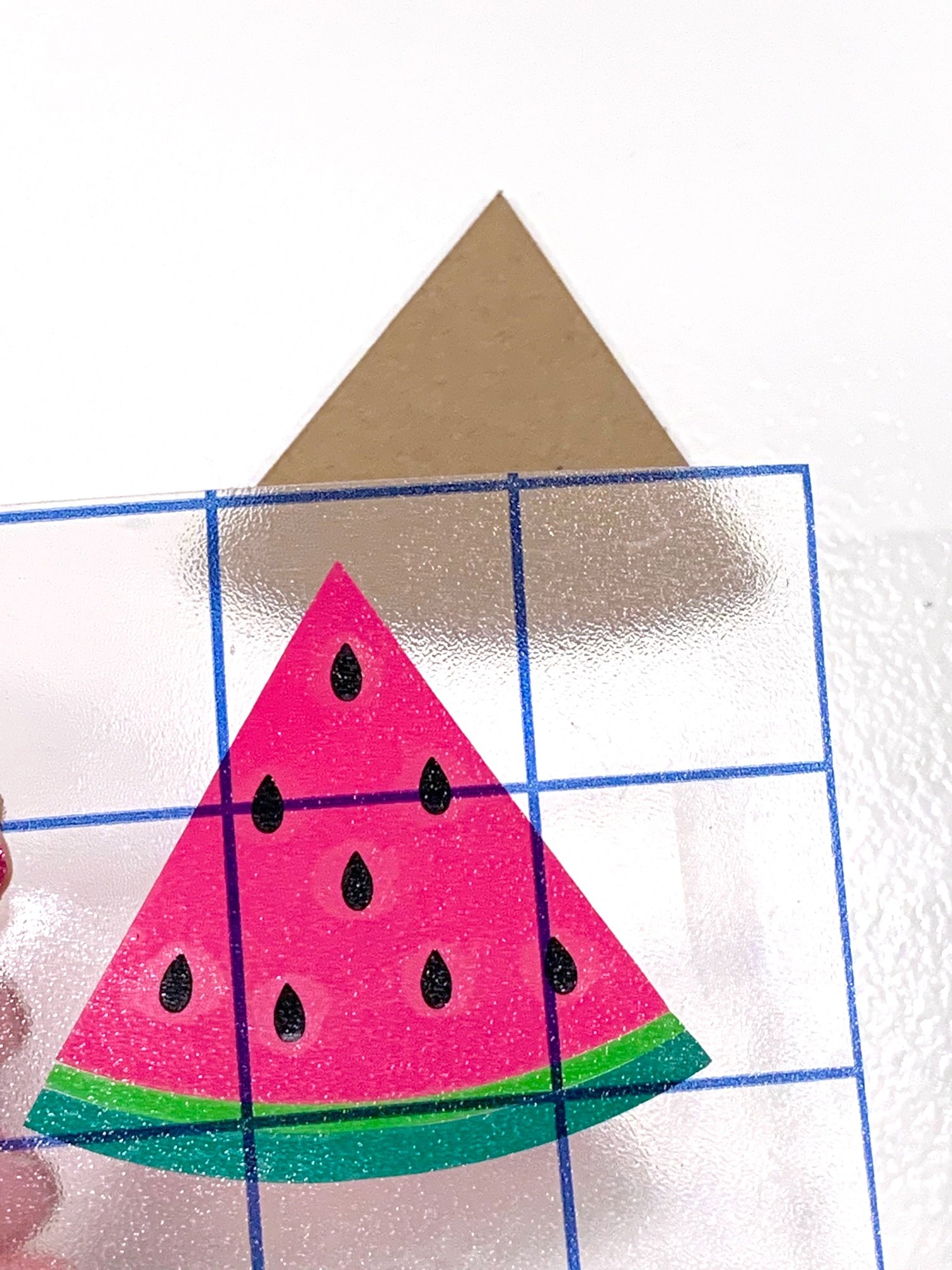 lining up watermelon vinyl on chipboard watermelon cut out for earrings