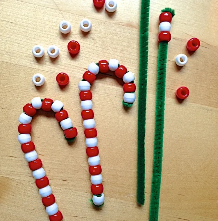 beaded candy cane made from pipe cleaners with supplies laid out
