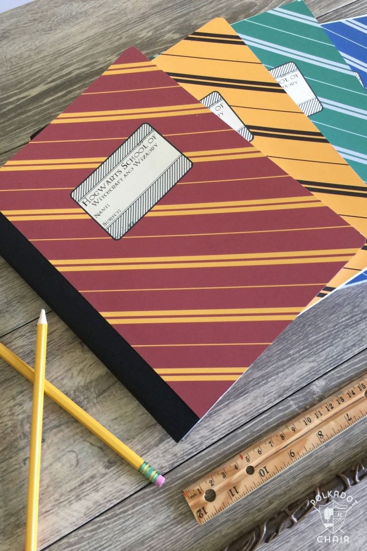 notebooks wrapped as harry potter house colors next to two pencils