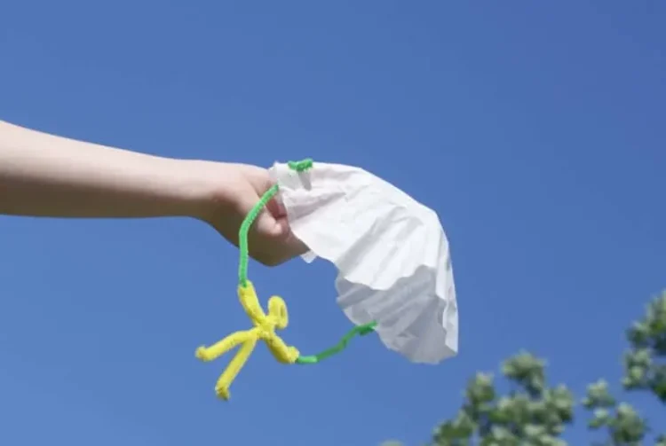 parachute man made from pipe cleaners and coffee filters