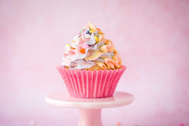 rainbow iced pinata cupcake on platter