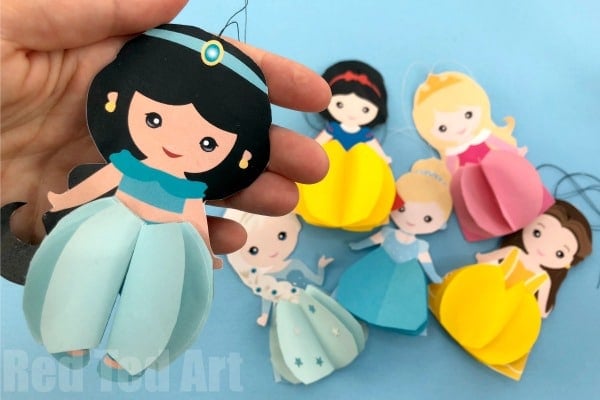 disney princess paper dolls being held