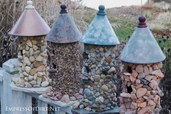 birdhouses covered in stones