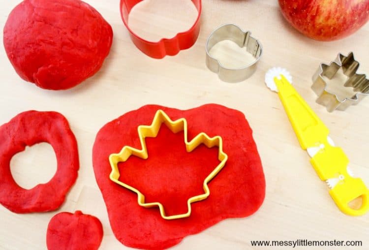 maple leaf cookie cutter being pressed into apple scented playdough 