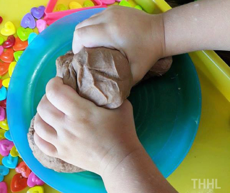 little hands kneading chocolate playdough