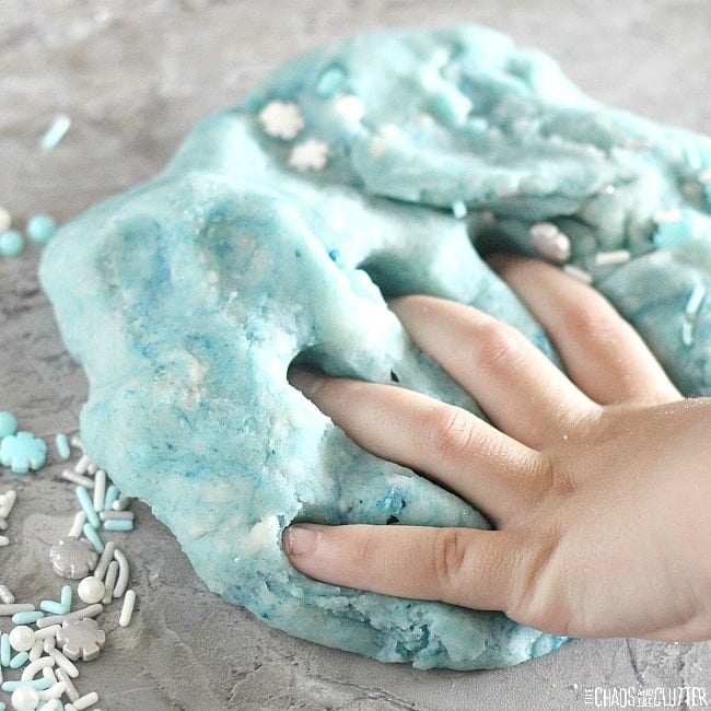 hand squishing frozen themed playdough