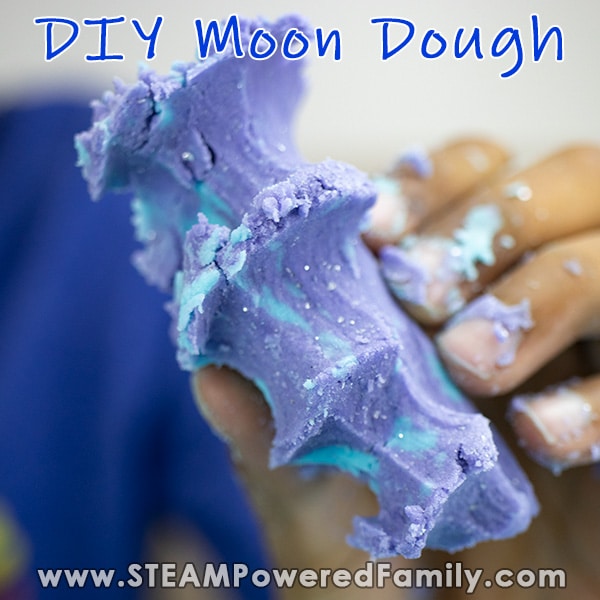 DIY moon dough being squished in hands