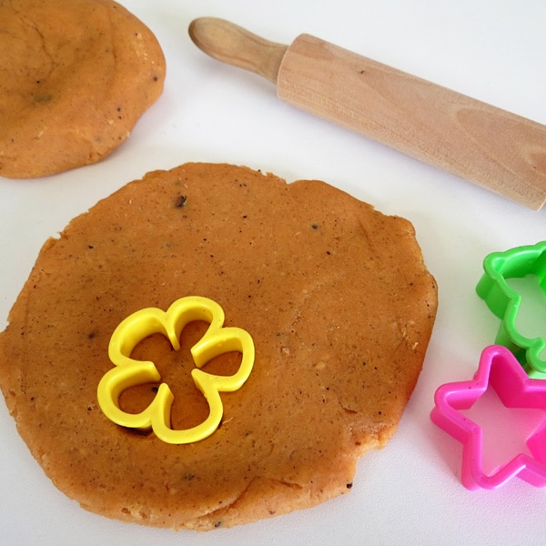 cookie cutter pressed onto spiced citrus playdough with rolling pin