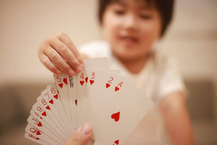 child picking a card from hand