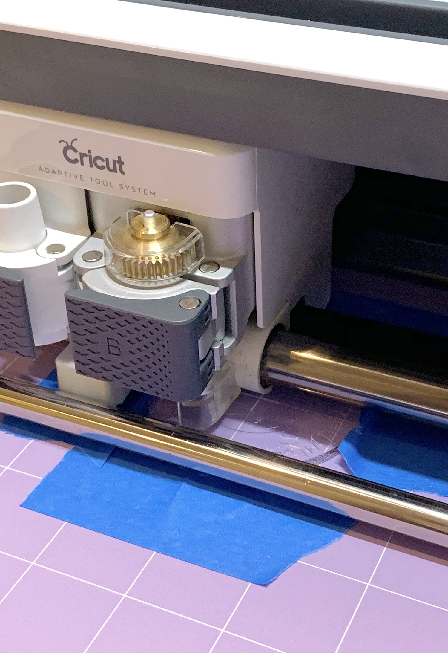 Cricut Maker machine engraving an acrylic disc with the Cricut Engraving Tool Tip