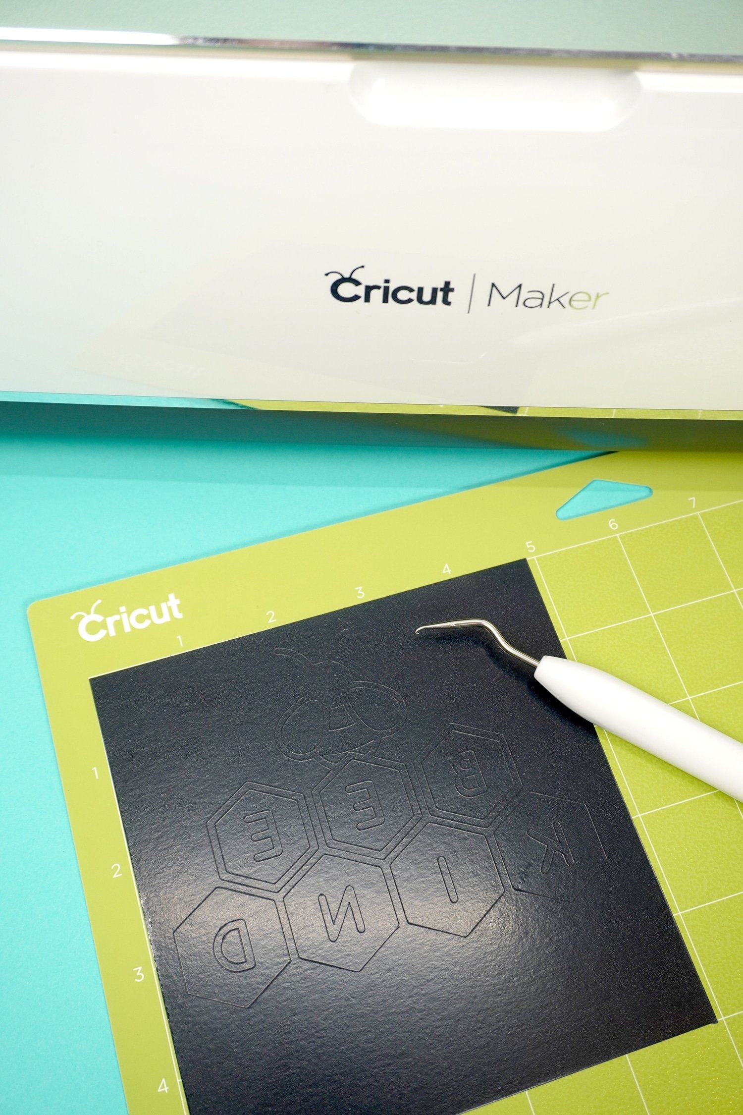 weeding the cut iron on vinyl on cricut cutting mat